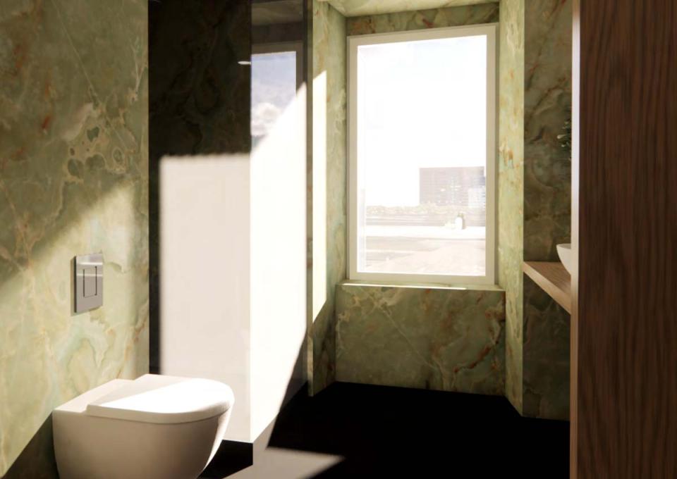 Modern bathroom with sunlight, green marble, and elegant details.